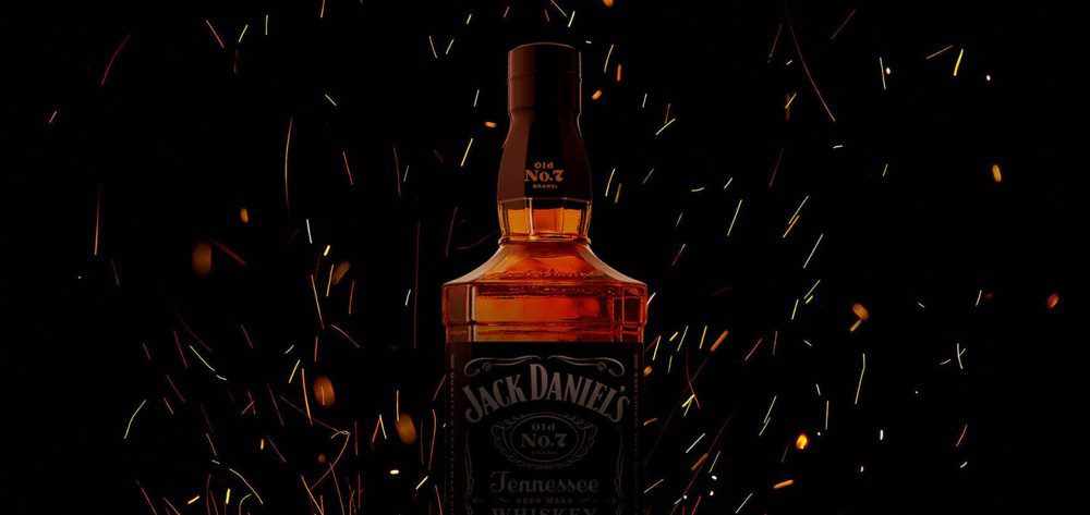 Bottle of Jack Daniel's surrounded by sparks from a fire