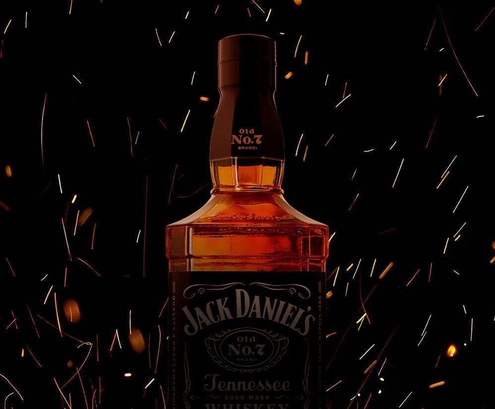 Bottle of Jack Daniel's surrounded by sparks from a fire