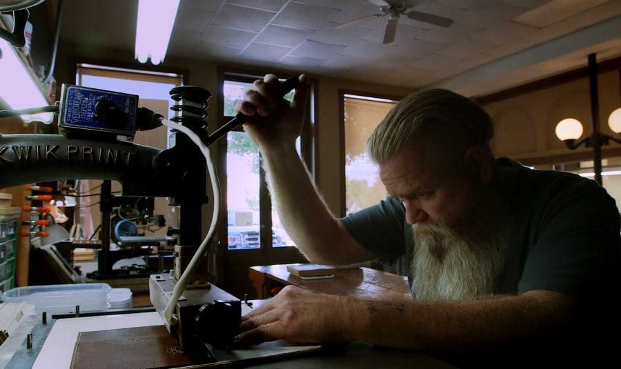 Man at leather press