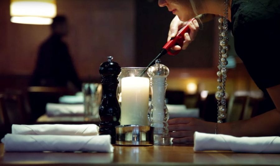 J. Alexander's hostess lighting a candle