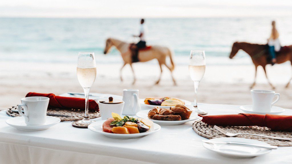 A table is set with a horse in the background.