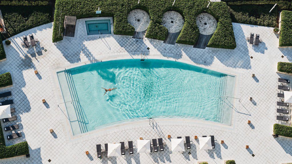 An aerial view of a swimming pool and lounge chairs.