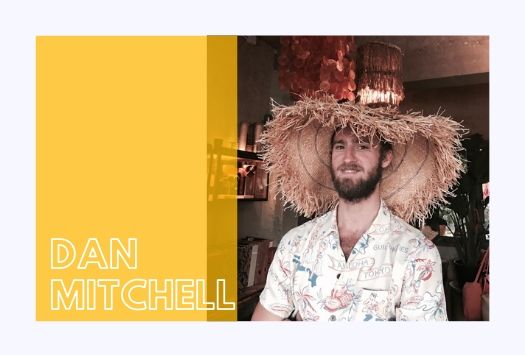Dan Mitchell wearing a stray hat and patterned shirt in a bar