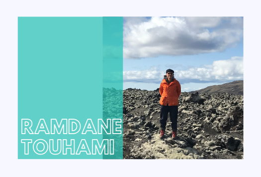 Ramdane Touhami standing at a rocky area on a cloudy day