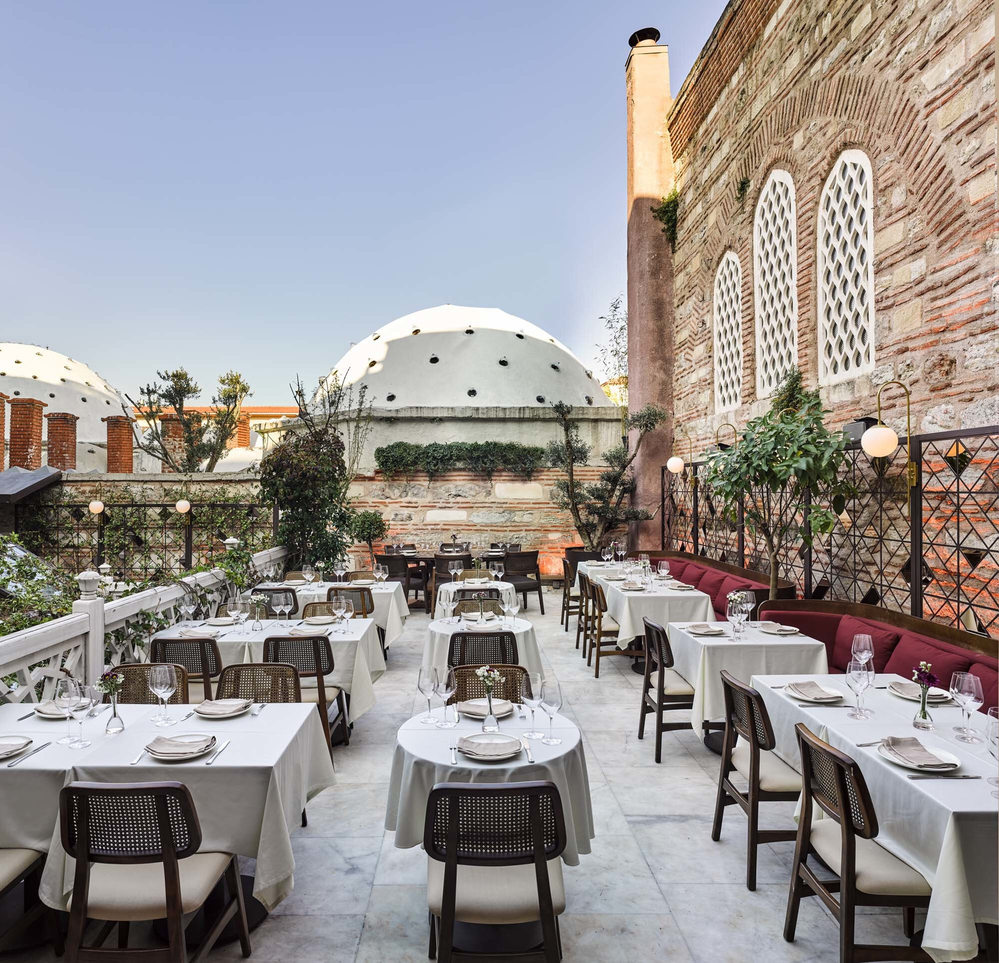 The tables aligned in 3 rows in Lokanta 1741, a Turkish restaurant on a sunny day