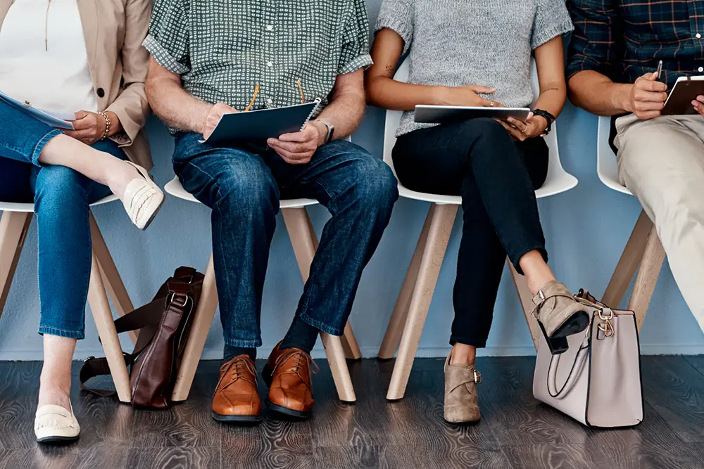 Group of employees solving problems on paper and tablets