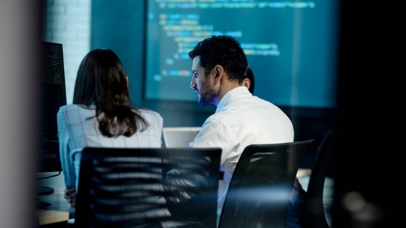 Two people in front of a computer screen responding to a social media crisis