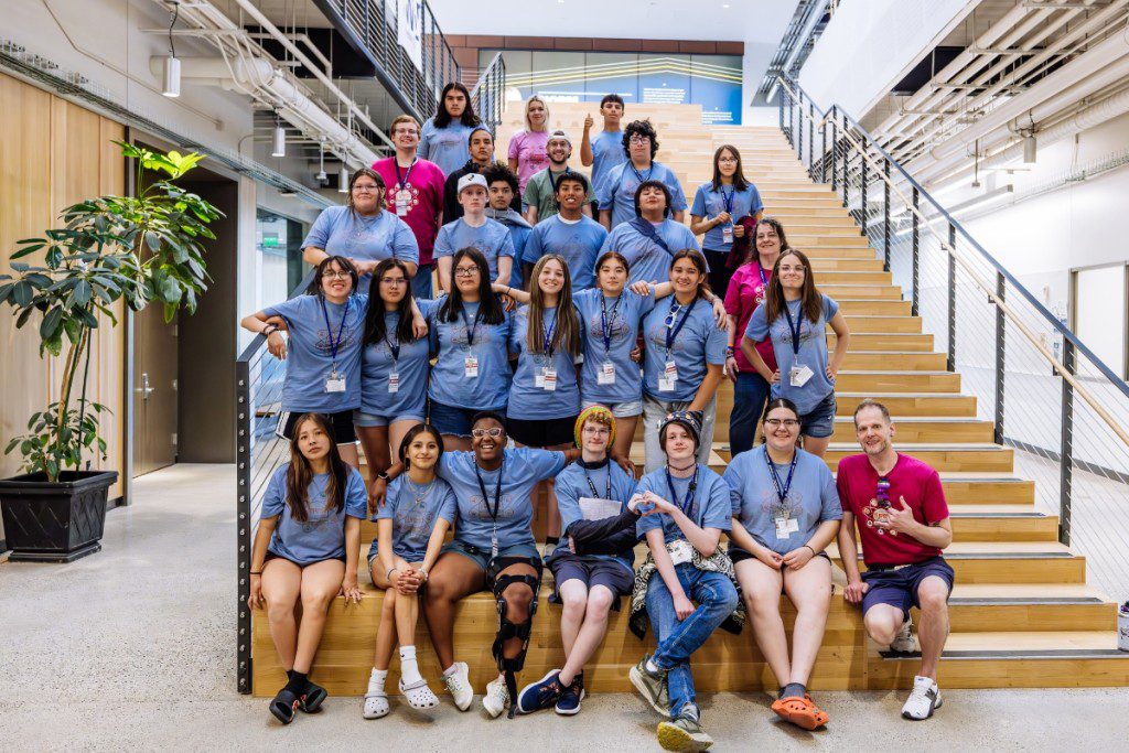 a group of students posing for a photo in an atrium
