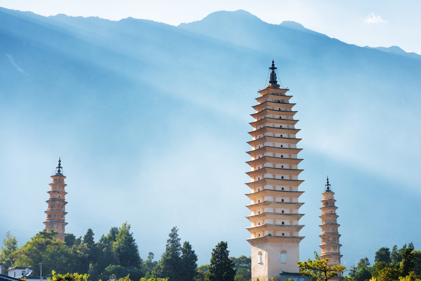 three pagodas in front of mountains in china