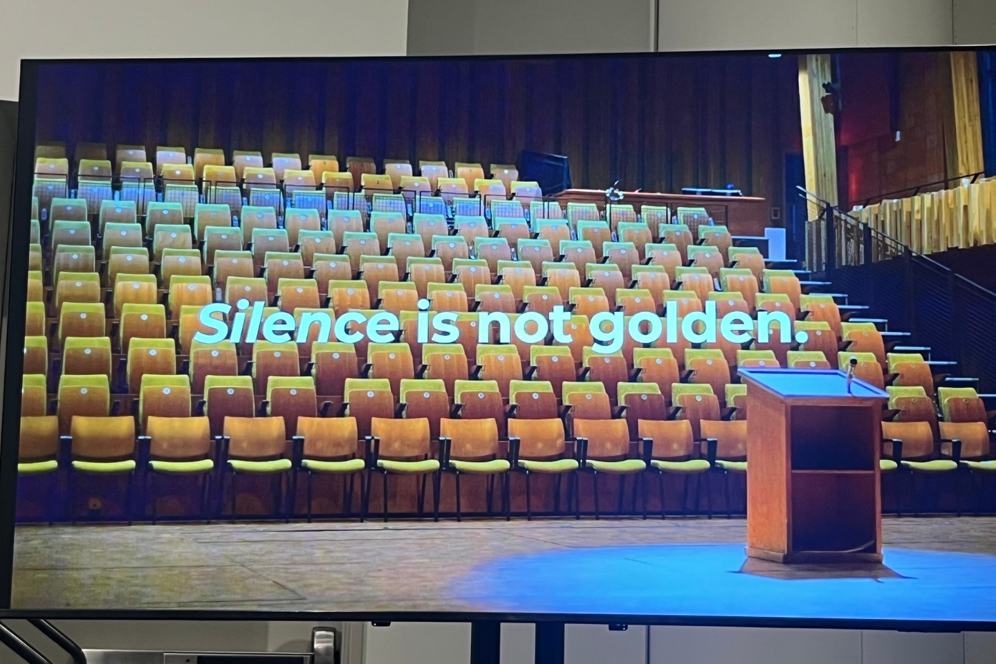 a photo a screen showing the words "silence is not golden" during a presentation about crisis communications and purpose