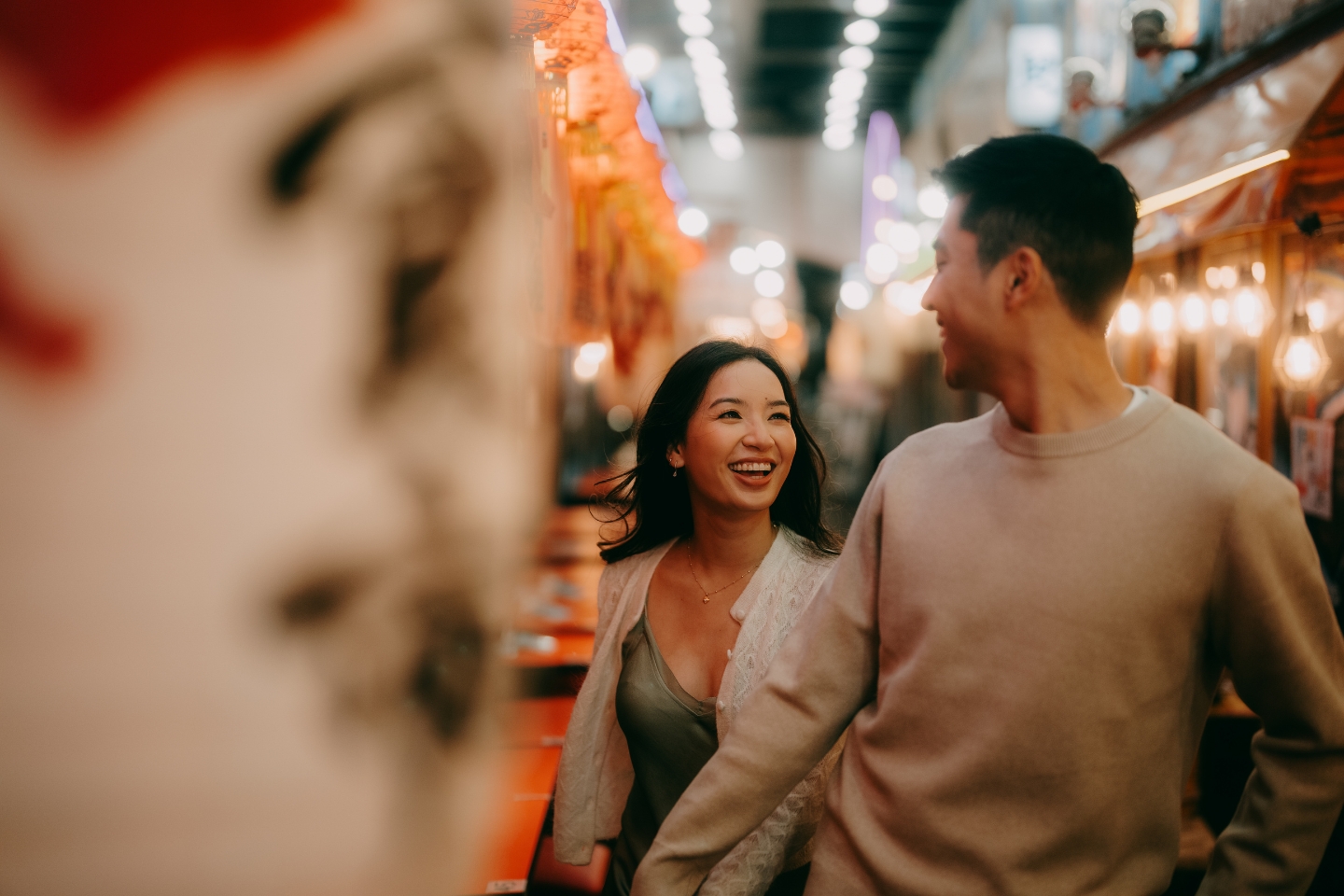 A couple walking through a market in Asia